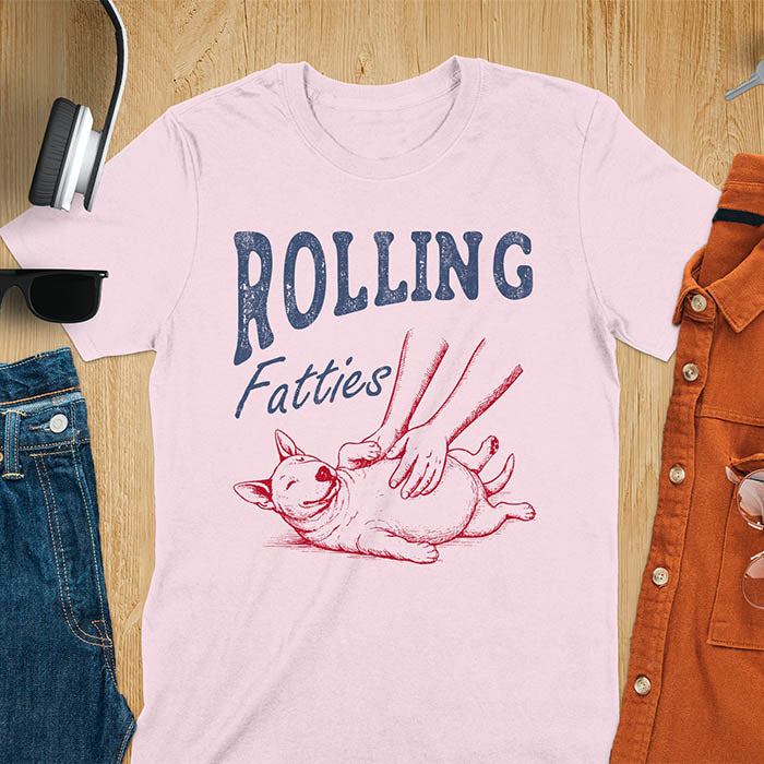 Light pink t-shirt with chubby Bull Terrier belly rub graphic featuring 'Rolling Fatties' text, funny dog meme design