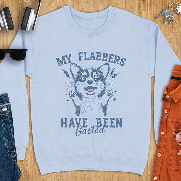 Light Blue sweatshirt with a corgi illustration, paws raised in shock, mouth open in a gasp, lightning bolts beside its ears, and the text My Flabbers Have Been Gasted