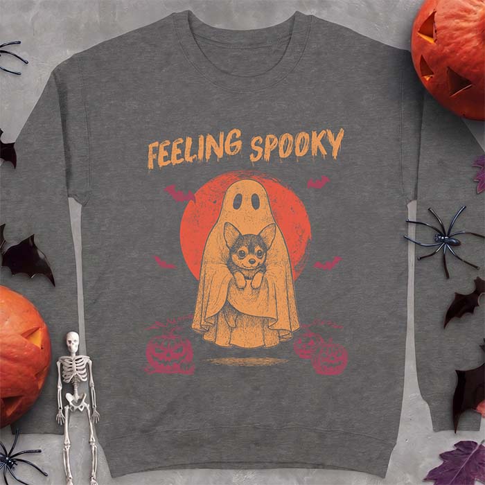 Dark Heather sweatshirt with a Halloween graphic of a ghost holding a wide-eyed Corgi puppy in front of a red moon with bats and jack-o-lanterns, with the text Feeling Spooky