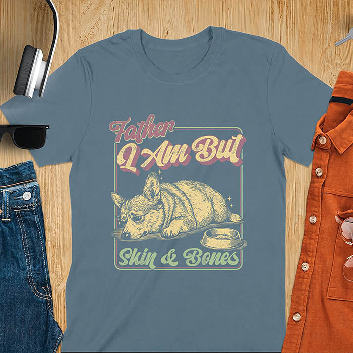 Indigo blue tee with corgi retro vintage graphic, empty bowl illustration and "Father I Am But Skin & Bones" text