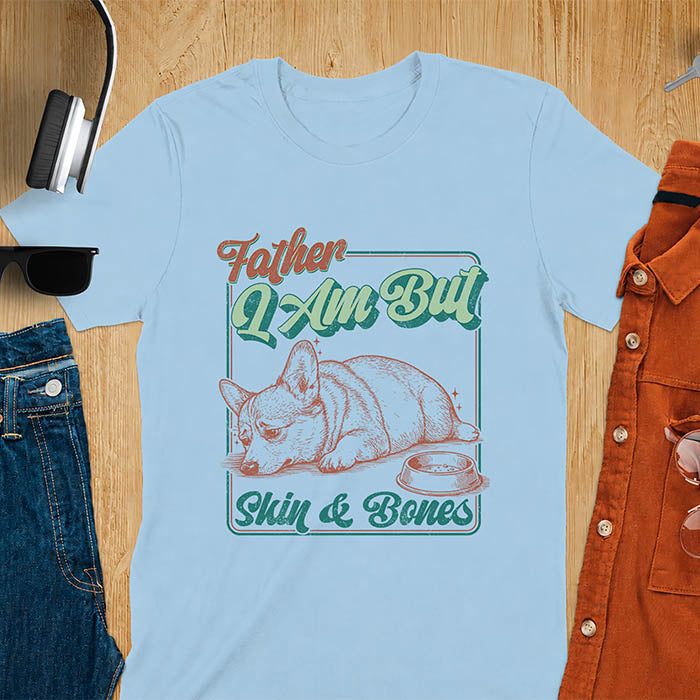Light blue tee with corgi retro vintage graphic, empty bowl illustration and "Father I Am But Skin & Bones" text