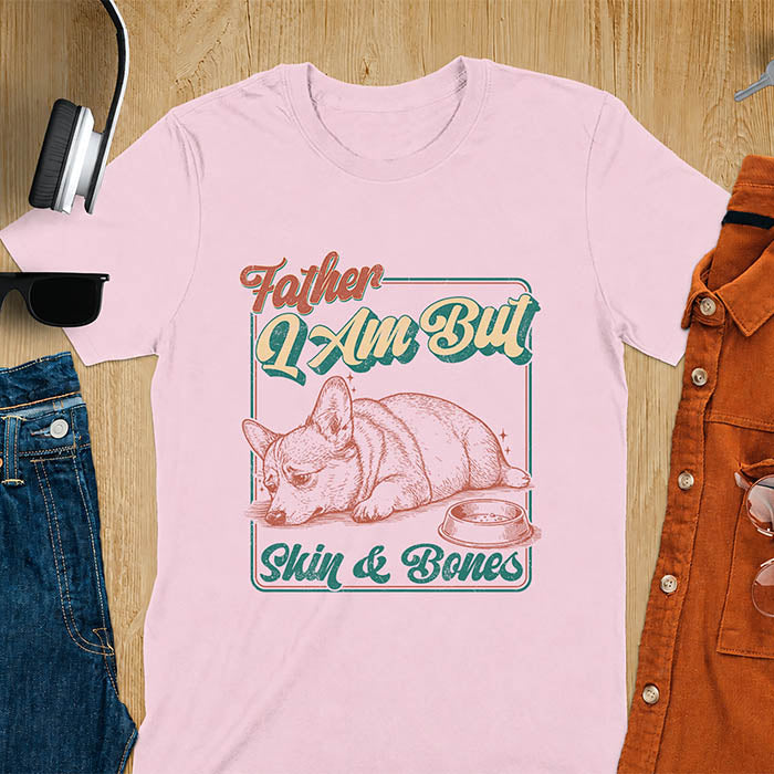 Light pink tee with corgi retro vintage graphic, empty bowl illustration and "Father I Am But Skin & Bones" text