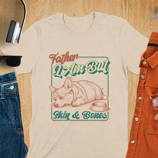 Sand color tee with corgi retro vintage graphic, empty bowl illustration and "Father I Am But Skin & Bones" text
