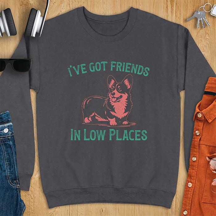 Dark heather sweatshirt with a vintage Corgi illustration standing and facing forward, with distressed teal text arched above reading "I'VE GOT FRIENDS" and below reading "IN LOW PLACES.