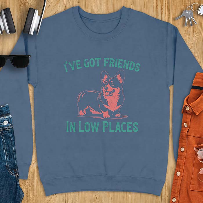 Indigo blue sweatshirt with a vintage Corgi illustration standing and facing forward, with distressed teal text arched above reading "I'VE GOT FRIENDS" and below reading "IN LOW PLACES.
