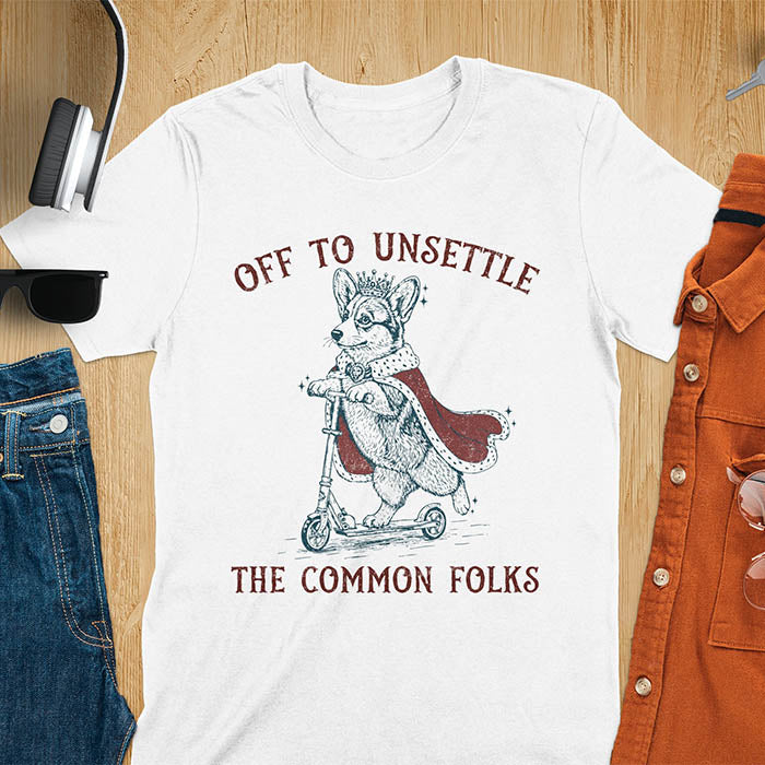 Off To Unsettle The Common Folks text with king corgi wearing crown and red cape on skateboard scooter vintage meme graphic on white t-shirt