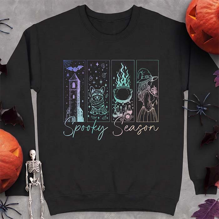 Black sweatshirt with a four-panel Halloween graphic of a haunted tower, a bandage-wrapped Corgi mummy, a bubbling cauldron with potion bottles and a witch holding flowers, with the text Spooky Season