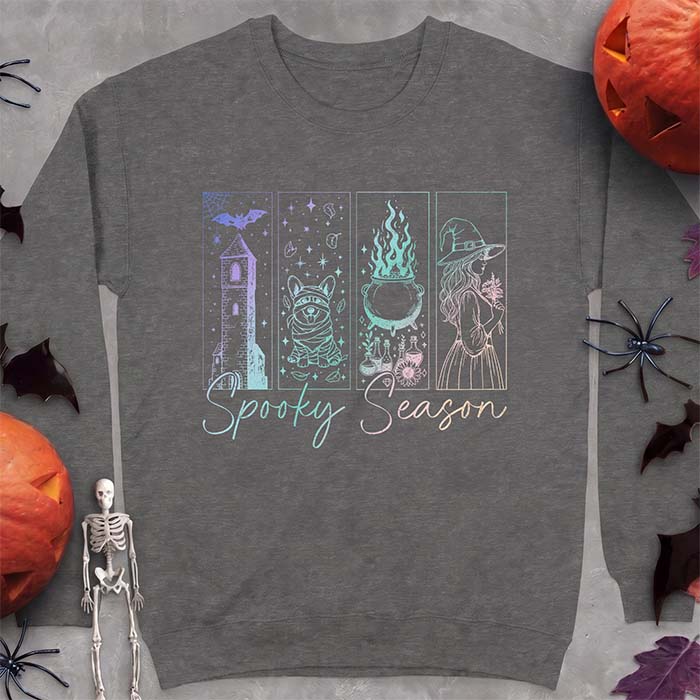 Dark Heather sweatshirt with a four-panel Halloween graphic of a haunted tower, a bandage-wrapped Corgi mummy, a bubbling cauldron with potion bottles and a witch holding flowers, with the text Spooky Season