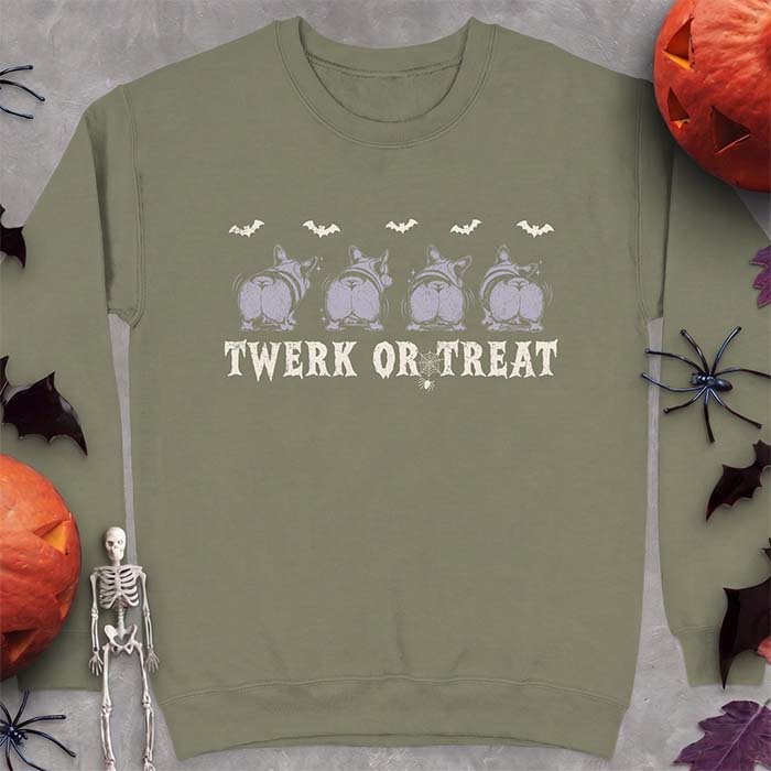 Military Green sweatshirt with a Halloween graphic of four Corgis viewed from behind shaking their rumps, bats flying above and a spider on a web, with the text Twerk Or Treat