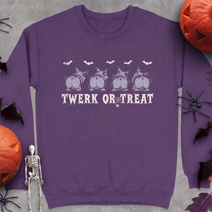 Purple sweatshirt with a Halloween graphic of four Corgis viewed from behind shaking their rumps, bats flying above and a spider on a web, with the text Twerk Or Treat
