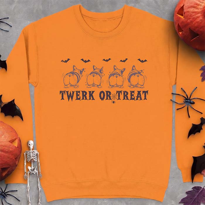 Safety Orange sweatshirt with a Halloween graphic of four Corgis viewed from behind shaking their rumps, bats flying above and a spider on a web, with the text Twerk Or Treat