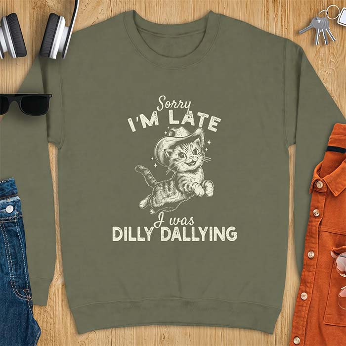 Military Green sweatshirt with a graphic of a kitten wearing a cowboy hat leaping through the air with sparkle accents and the text Sorry I'm Late I Was Dilly Dallying
