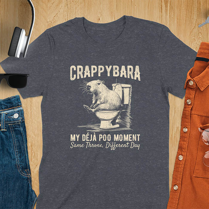A humorous graphic of a capybara sitting on a toilet with the text Crappybara above and Déjà Poo Moment: same throne, different day below. A funny design for animal and meme lovers.