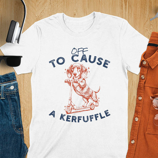 Dachshund on kick scooter illustrated graphic with Off To Cause A Kerfuffle text on white t-shirt
