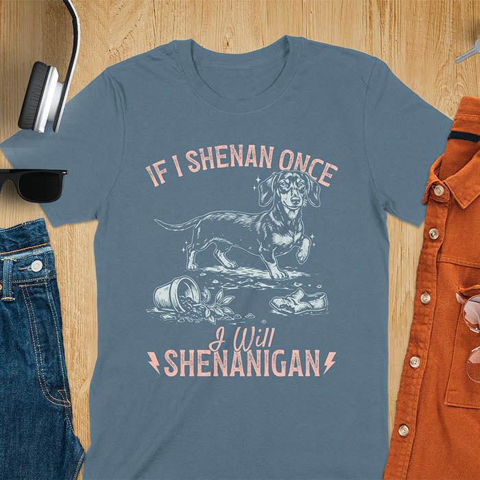 Indigo blue t-shirt with If I Shenan Once I Will Shenanigan text and Dachshund illustration surrounded by chaos