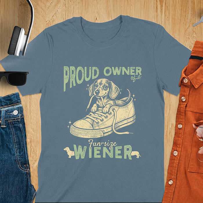 Indigo Blue unisex t-shirt with a vintage dachshund graphic of a wiener dog pup sitting inside a classic sneaker, with retro bold lettering reading Proud Owner of a Fun-Size Wiener