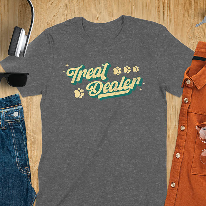 Dark heather t-shirt with Treat Dealer text in retro script typography with green and yellow colors and paw print decorations