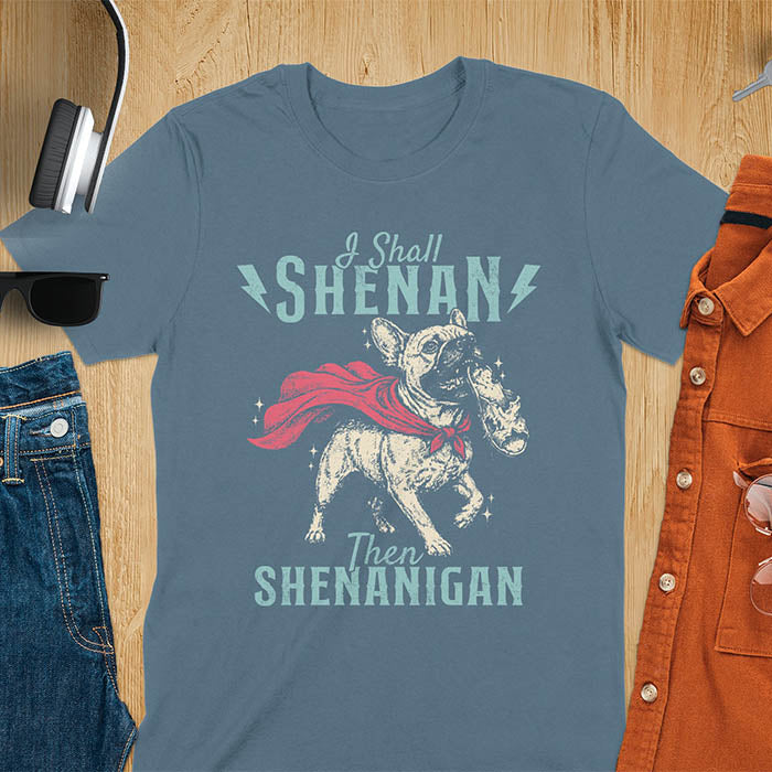 Indigo Blue tee with vintage Frenchie in red cape biting on a chewed slipper, text reads I Shall Shenan Then Shenanigan