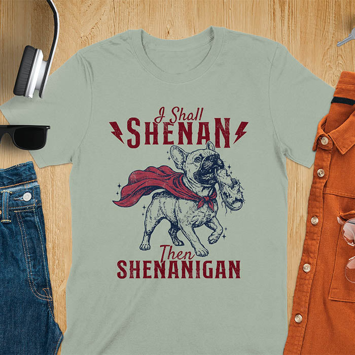 Sage green  tee with vintage Frenchie in red cape biting on a chewed slipper, text reads I Shall Shenan Then Shenanigan