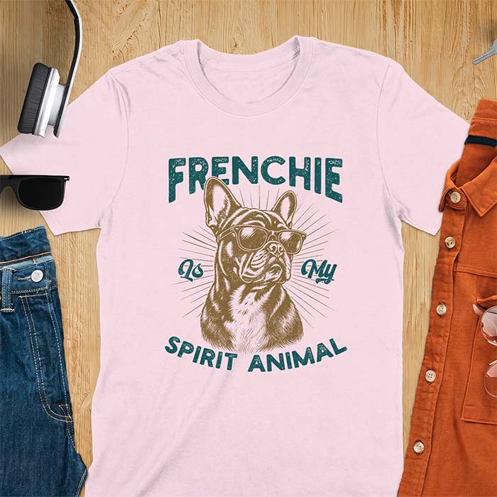 Light Pink t-shirt featuring a sunglasses-wearing French Bulldog with sunburst rays behind it and the text Frenchie Is My Spirit Animal.