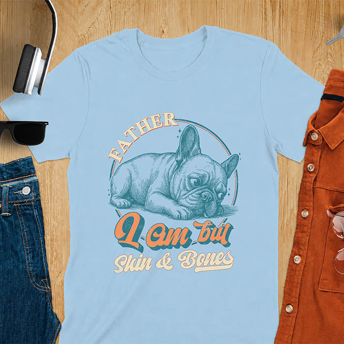 Light blue t-shirt with funny vintage French Bulldog graphic print reading "Father I Am But Skin & Bones" in retro typography