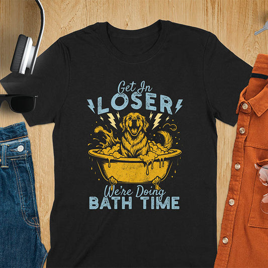 Golden Retriever sitting in a bathtub with soap bubbles and lightning bolts, with the text Get In Loser We're Doing Bath Time on a black t-shirt
