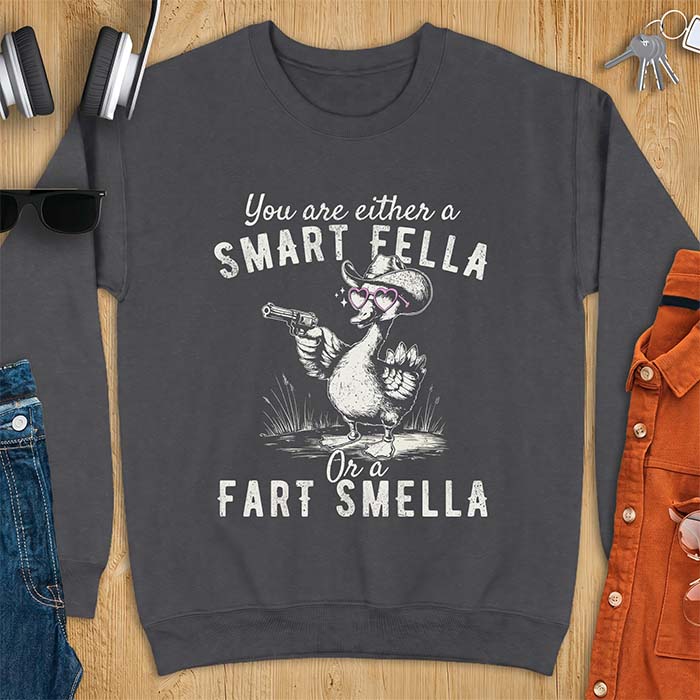 Dark Heather sweatshirt with a cowboy goose illustration wearing a hat and pink heart shaped sunglasses, holding a revolver, and the text You Are Either A Smart Fella Or A Fart Smella