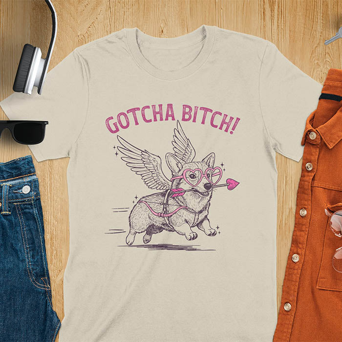 Gotcha Bitch Corgi cupid with angel wings heart glasses and arrow graphic tee on sand color shirt