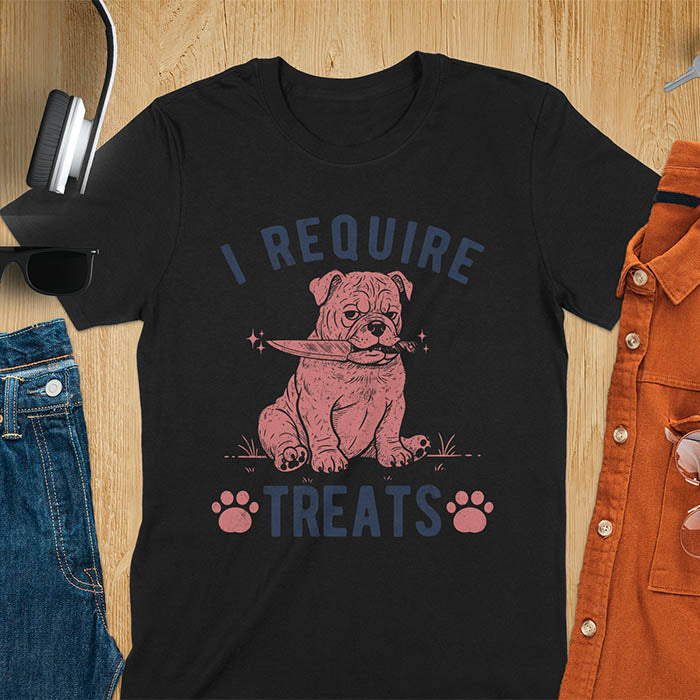 Black tee with "I Require Treats" text and grumpy bulldog puppy holding knife in mouth and paw prints vintage graphic