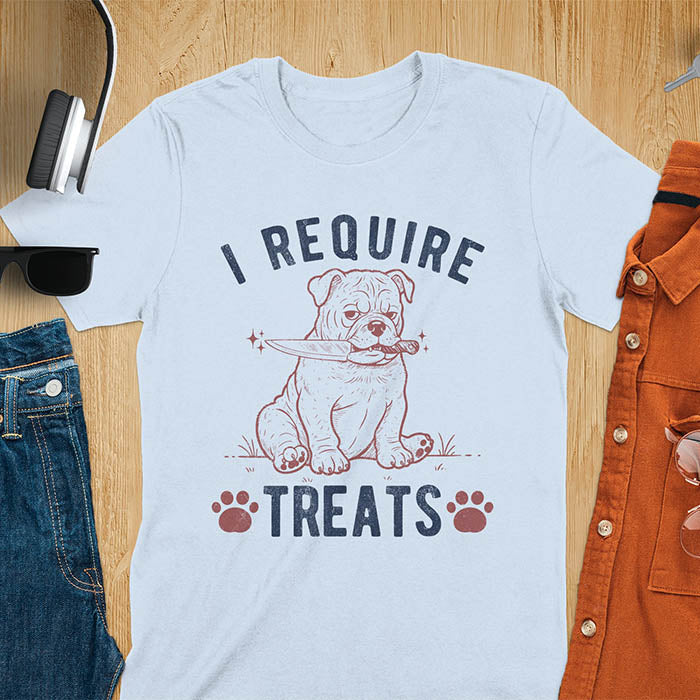 Light blue tee with "I Require Treats" text and grumpy bulldog puppy holding knife in mouth and paw prints vintage graphic