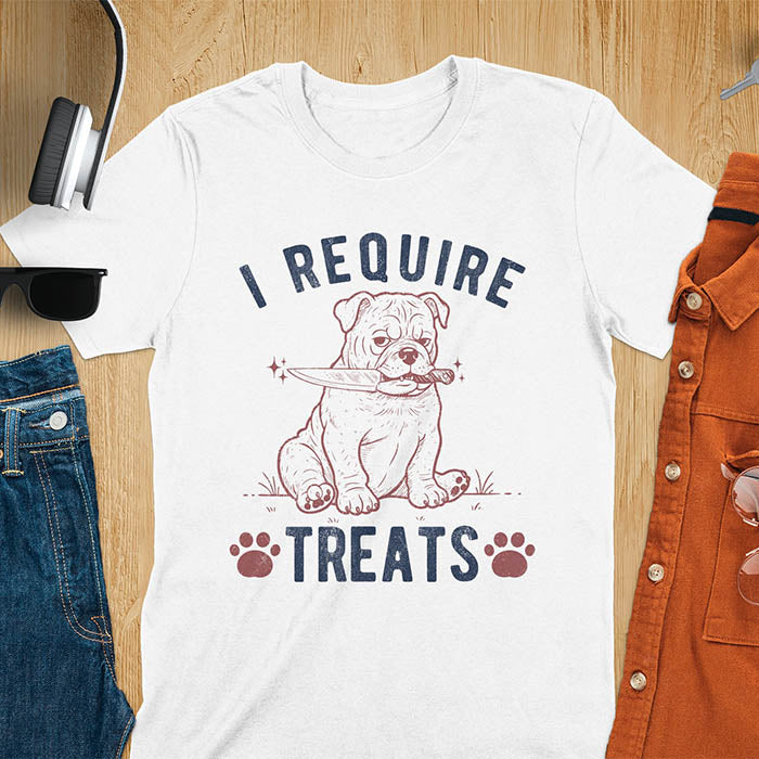 White tee with "I Require Treats" text and grumpy bulldog puppy holding knife in mouth and paw prints vintage graphic