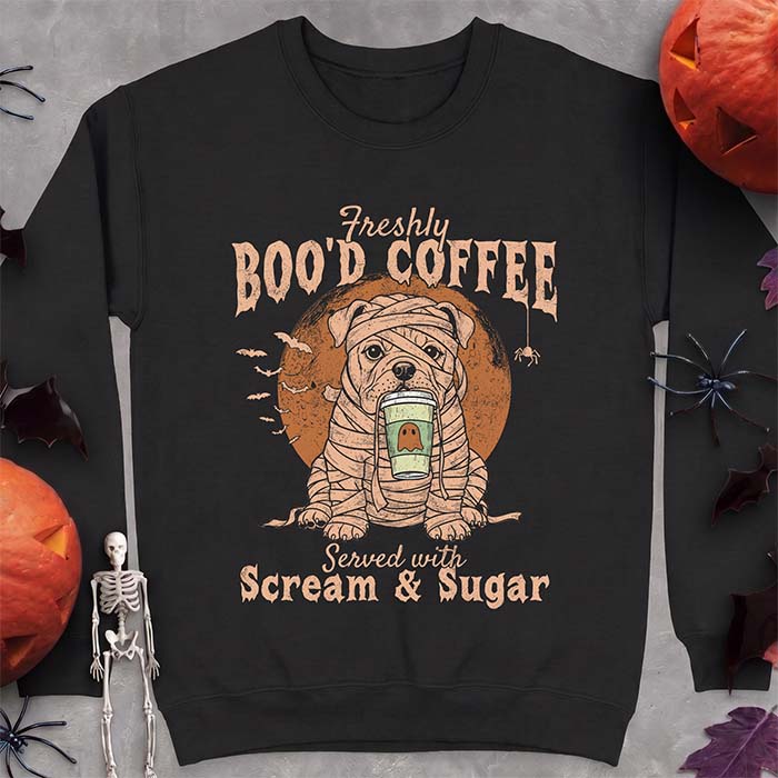 Black sweatshirt with a Halloween graphic of a bulldog wrapped as a mummy holding a coffee cup, bats and a spider under a moon and the text Freshly Boo'd Coffee served with scream & sugar