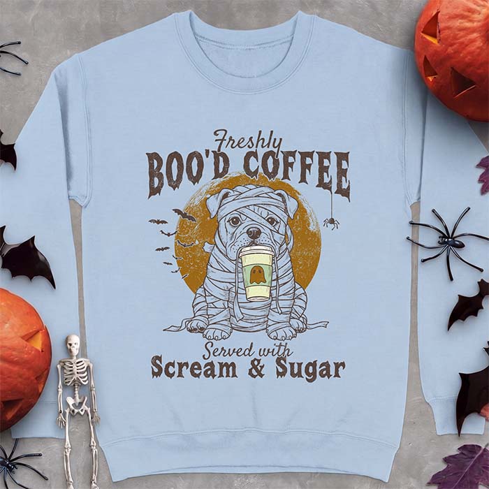 Light Blue sweatshirt with a Halloween graphic of a bulldog wrapped as a mummy holding a coffee cup, bats and a spider under a moon and the text Freshly Boo'd Coffee served with scream & sugar