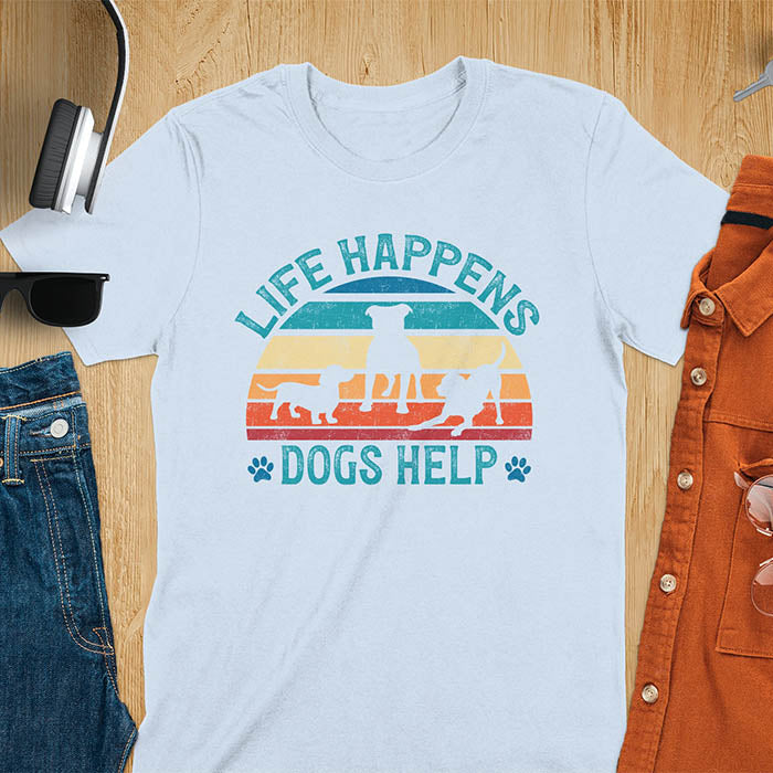 Life Happens Dogs Help vintage retro sunset with dog silhouettes and paw prints on light blue t-shirt