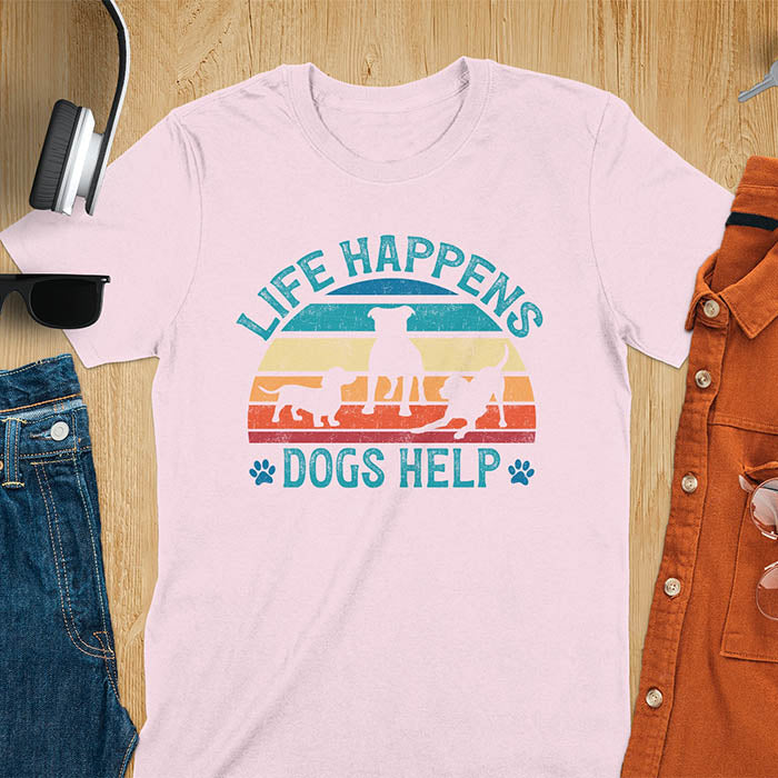 Life Happens Dogs Help vintage retro sunset with dog silhouettes and paw prints on light pink t-shirt