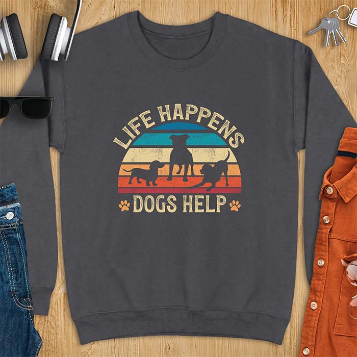 Dark Heather sweatshirt with a retro striped sunset graphic of three dog silhouettes trotting together and paw prints on either side and the text Life Happens Dogs Help