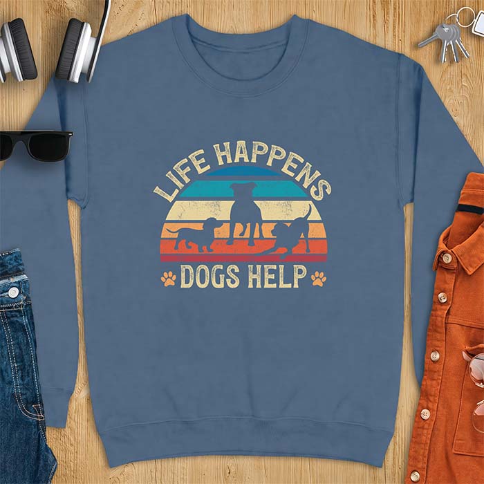 Indigo Blue sweatshirt with a retro striped sunset graphic of three dog silhouettes trotting together and paw prints on either side and the text Life Happens Dogs Help