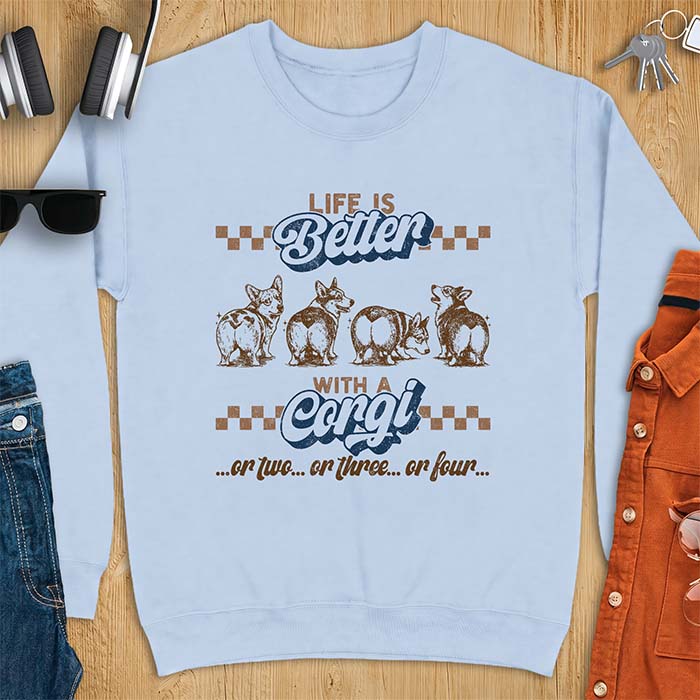 Light Blue sweatshirt with a retro graphic of four corgis shown from behind in a row, plus the text Life Is Better With A Corgi, or two, or three, or four