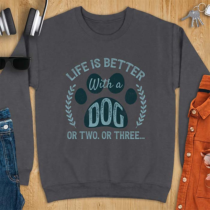 Dark Heather sweatshirt with a graphic of a large paw framed by a laurel wreath on either side and the text Life Is Better With a Dog Or Two Or Three
