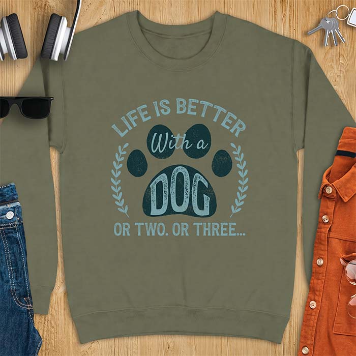 Military Green sweatshirt with a graphic of a large paw print framed by a laurel wreath on either side and the text Life Is Better With a Dog Or Two Or Three