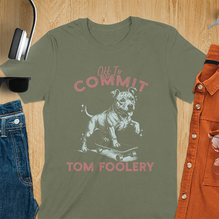 Military green t-shirt featuring a pitbull riding a skateboard with text Off To Commit Tom Foolery in vintage red lettering