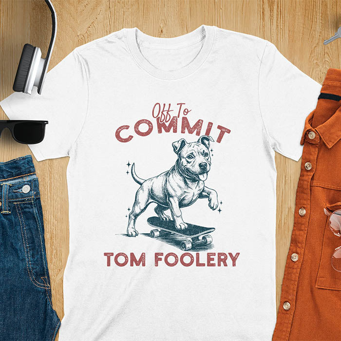 White t-shirt featuring a pitbull riding a skateboard with text Off To Commit Tom Foolery in vintage red lettering