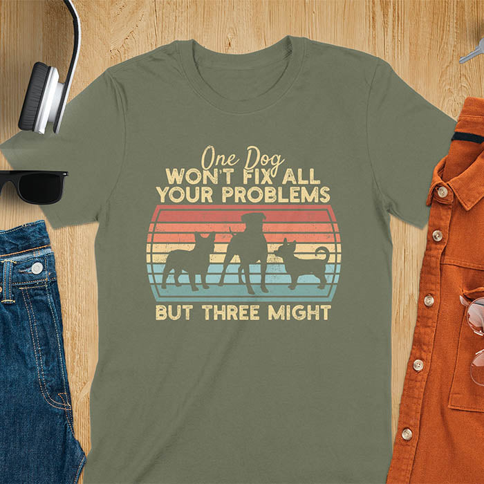 Military Green t-shirt with text 'One dog won't fix all your problems but three might' and three dog silhouettes on vintage sunset stripes