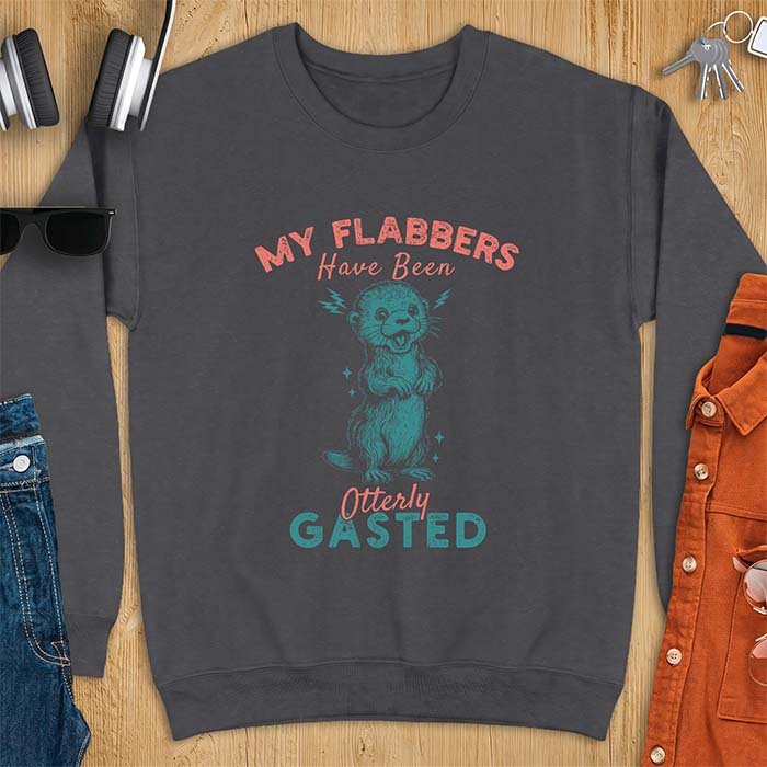 Dark Heather sweatshirt with a graphic of a startled otter standing upright with paws clasped and mouth open in shock with lightning bolts on either side, featuring the text My Flabbers Have Been Otterly Gasted.