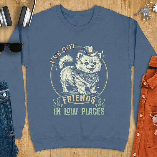 Indigo Blue sweatshirt with a vintage western illustration of a fluffy Pomeranian wearing a cowboy hat and a paisley bandana, with the text I've Got arched above it and Friends In Low Places below it