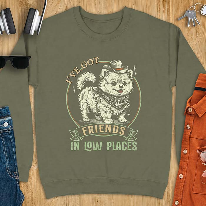 Military Green sweatshirt with a vintage western illustration of a fluffy Pomeranian wearing a cowboy hat and a paisley bandana, with the text I've Got arched above it and Friends In Low Places below it