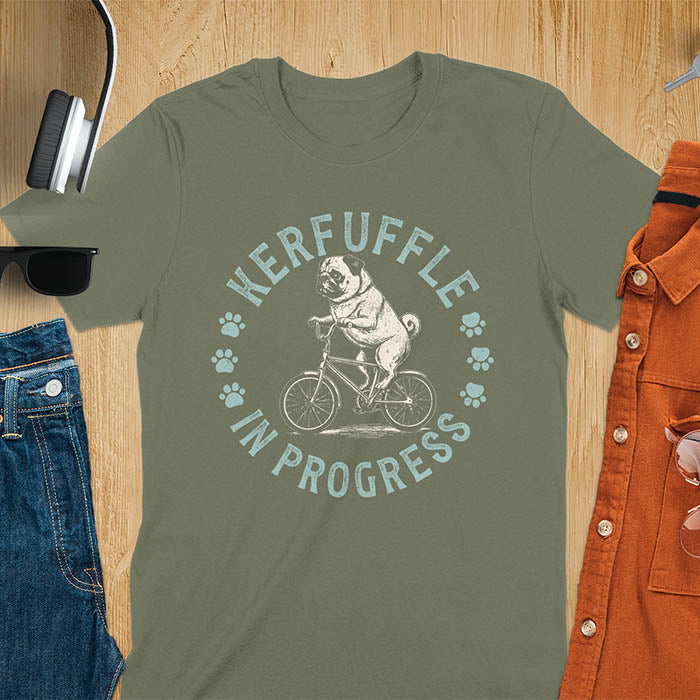 Pug on bicycle sketch-style graphic with Kerfuffle In Progress text and paw prints on military green t-shirt