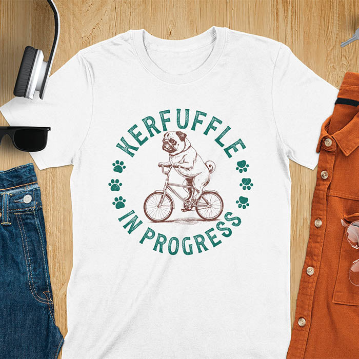 Pug on bicycle sketch-style graphic with Kerfuffle In Progress text and paw prints on white t-shirt