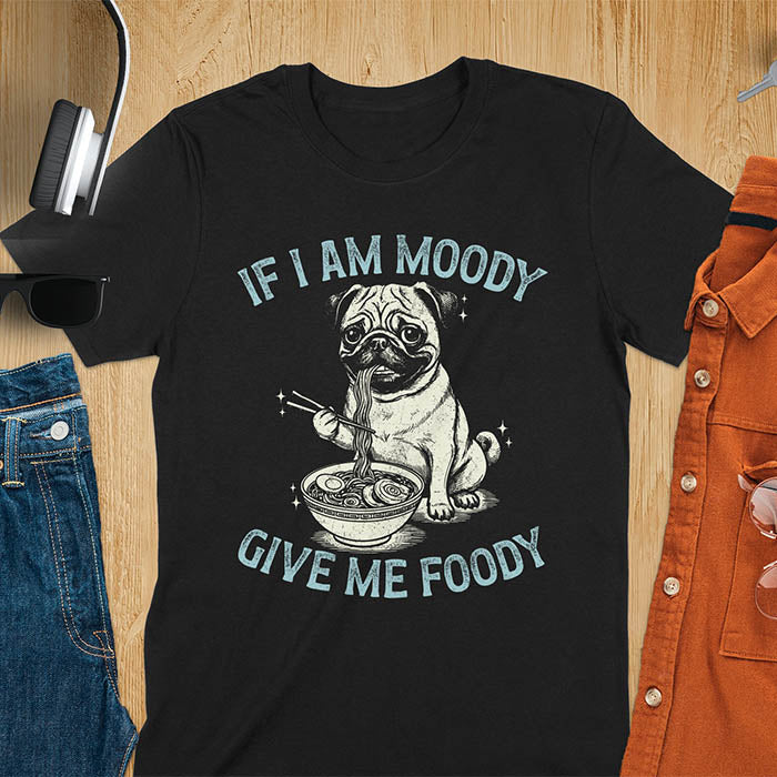 Black t-shirt with pug eating ramen with chopsticks graphic featuring 'If I Am Moody Give Me Foody' text - funny dog meme design.