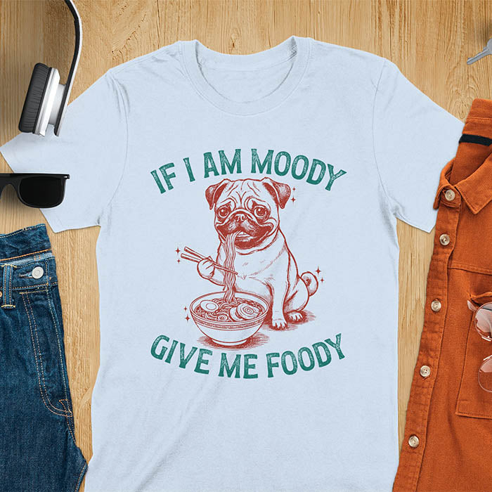 Light blue t-shirt with pug eating ramen with chopsticks graphic featuring 'If I Am Moody Give Me Foody' text - funny dog meme design